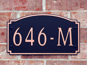 Custom address plaque on brick wall