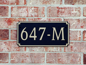Custom address plaque on brick wall