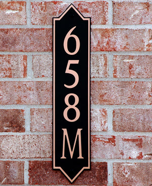 Custom address plaque on brick wall