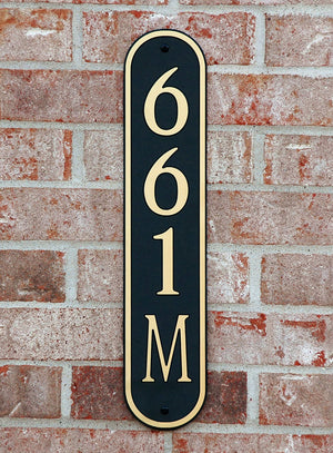 Custom address plaque on brick wall