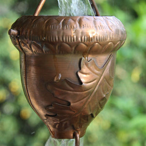 Autumn Oak Copper Rain Chain with water flowing through it