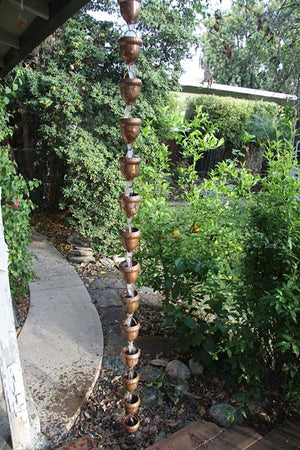 Autumn Oak Rain Chain on house with water flowing through multiple cups