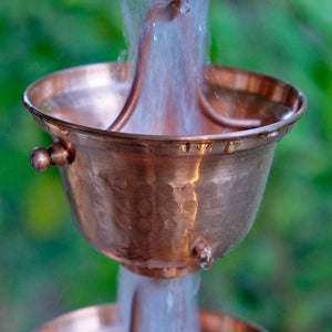 Copper Bell Cups Rain Chain with water flowing through cup
