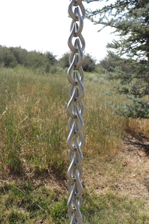 Longer length view of Cast Aluminum Droplet Rain Chain in clear powder-coated aluminum