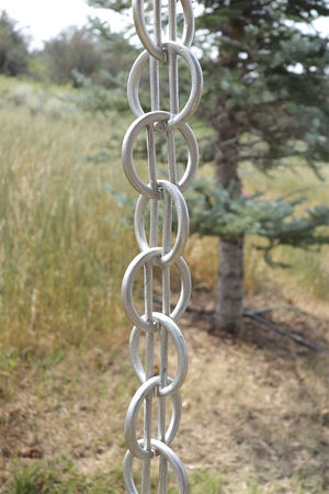 Longer length view of Cast Zen Loops Rain Chain in Aluminum