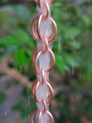 Full length image of Copper Double Loops Rain Chain with water running through it