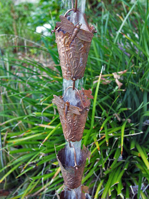 Dragonfly Theme Copper Rain Chain with water flowing through multiple cups