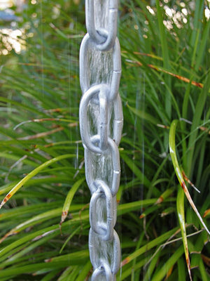 Closeup of aluminum Extra Link Rain Chain with water flowing through it