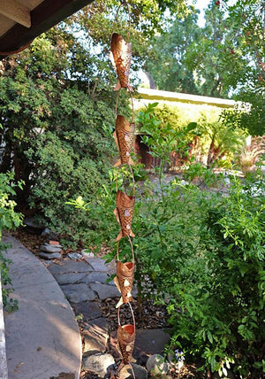 Fancy Koi fish shaped Rain Chain on house with water running through multiple cups