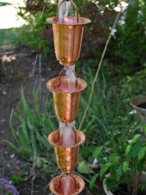 Flared Cups Rain Chain in copper with water flowing through multiple cups