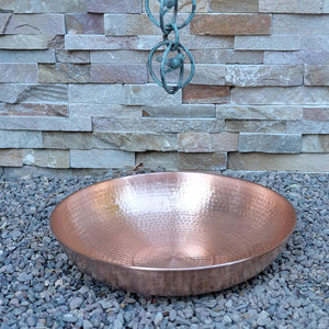 hammered copper dish under Rain Chain