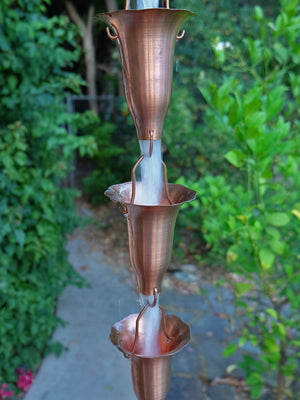 Copper Honeysuckle Rain Chain with water running through multiple cups