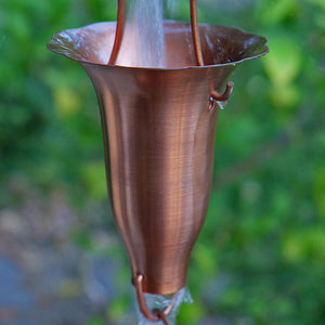 Copper Honeysuckle Rain Chain with water running through cup
