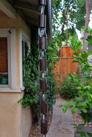 Kenchiku Rain Chain in Bronze with water running through the cups