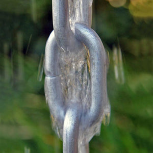 Large Link Rain Chain in silver with water running through it