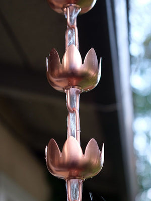 water flowing through lily flower cups rain chain made of copper plated stainless steel