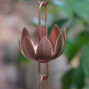 Close up of copper plated lily flower cups rain chain