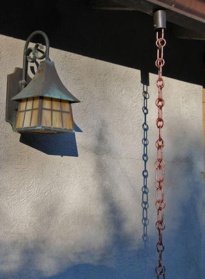 Link & Loop Copper Rain Chain hanging from a gutter