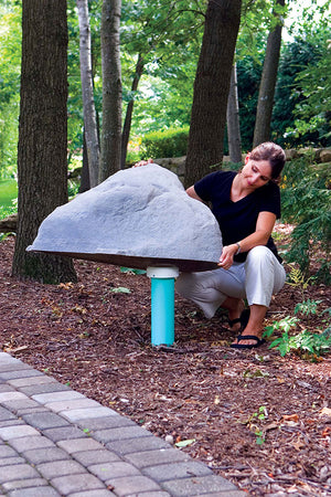 Classic Faux Rock Model 101 protecting pipes in yard