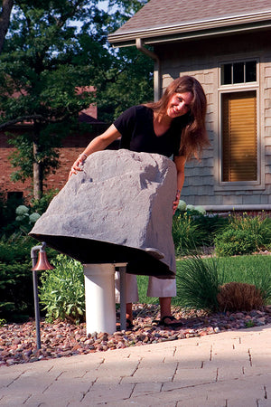 Tall Profile Faux Rock Model 102 protecting pipes in yard