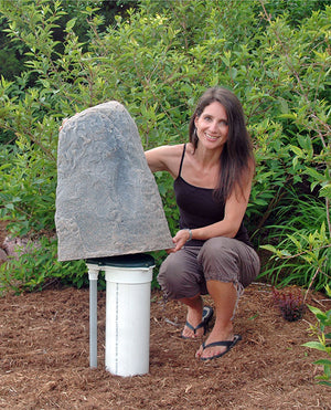 Medium Tall Profile Faux Rock Model 107 protecting pipes in yard