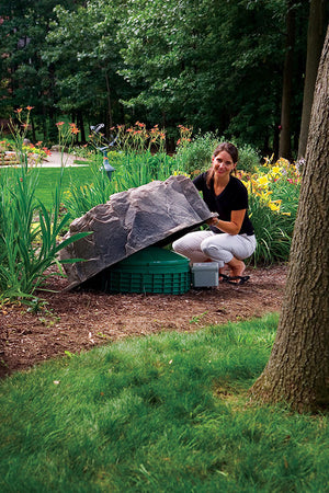 Medium Profile Faux Rock Model 111 in flower bed