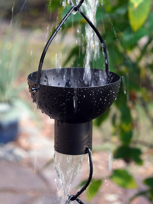 Black modern flower cup rain chain with water flowing through cup