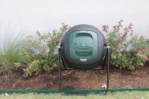 Ms.Tumbles® Compost Tumbler in flower bed