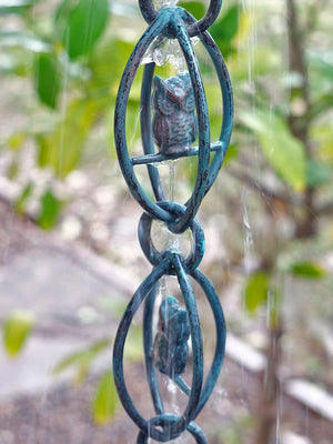 water running down Owl Rain Chain in Patina