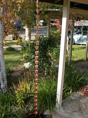 Shizuka Cups Rain Chain in copper hanging from a home
