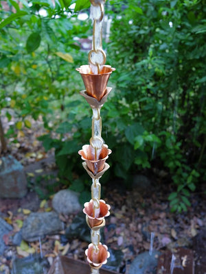 Multiple Small Copper Kanji Cups Rain Chain with water running through multiple cups
