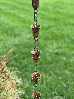 small kanji cups rain chain with trickle of water flowing through the cups
