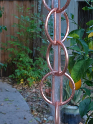 Close up of Zen Loops Copper Rain Chain with water flowing through it